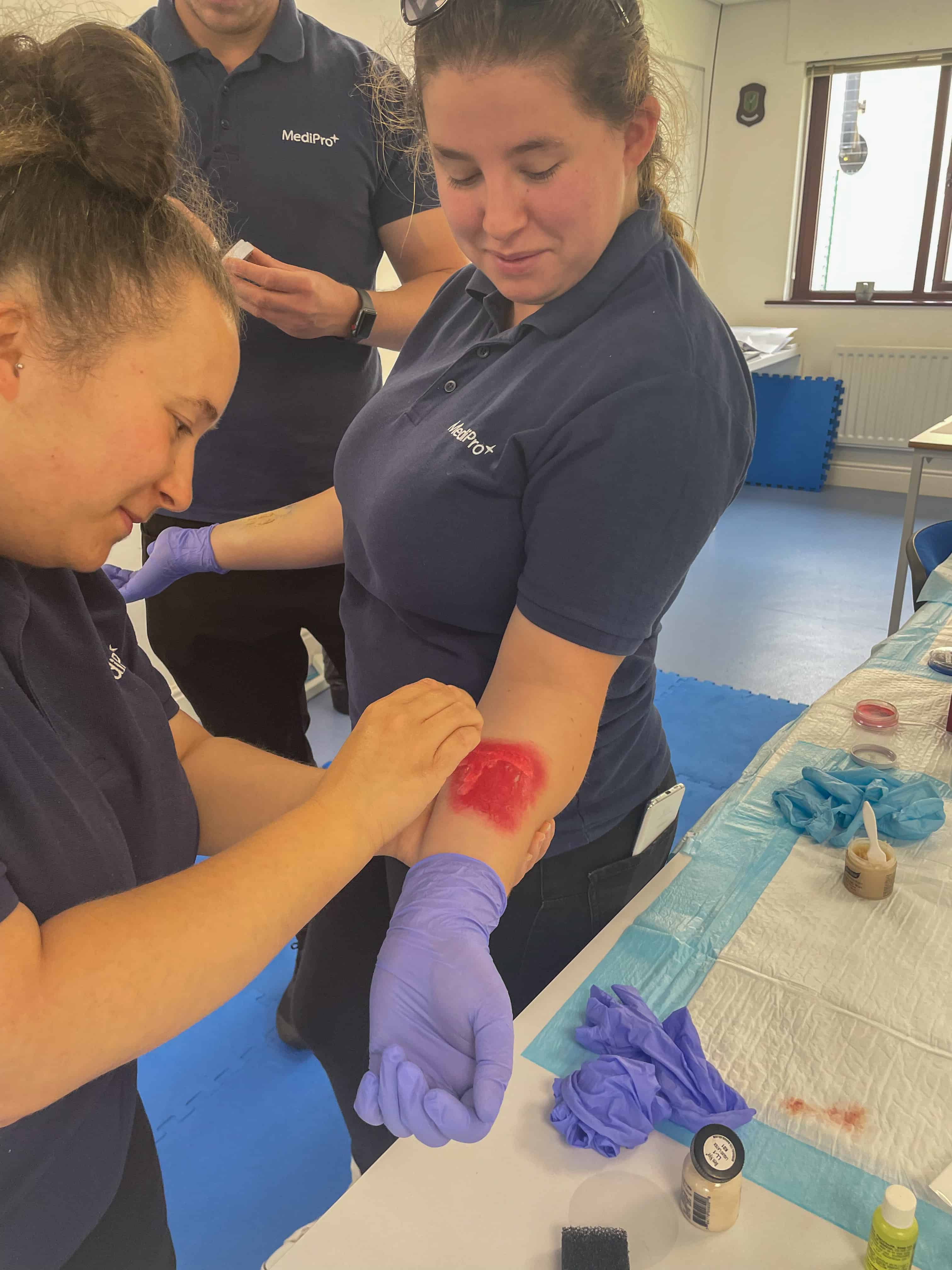 Our clinical tutors covering surgical airways  as part of a training day and using moulage make-up kits to teach simulations.
