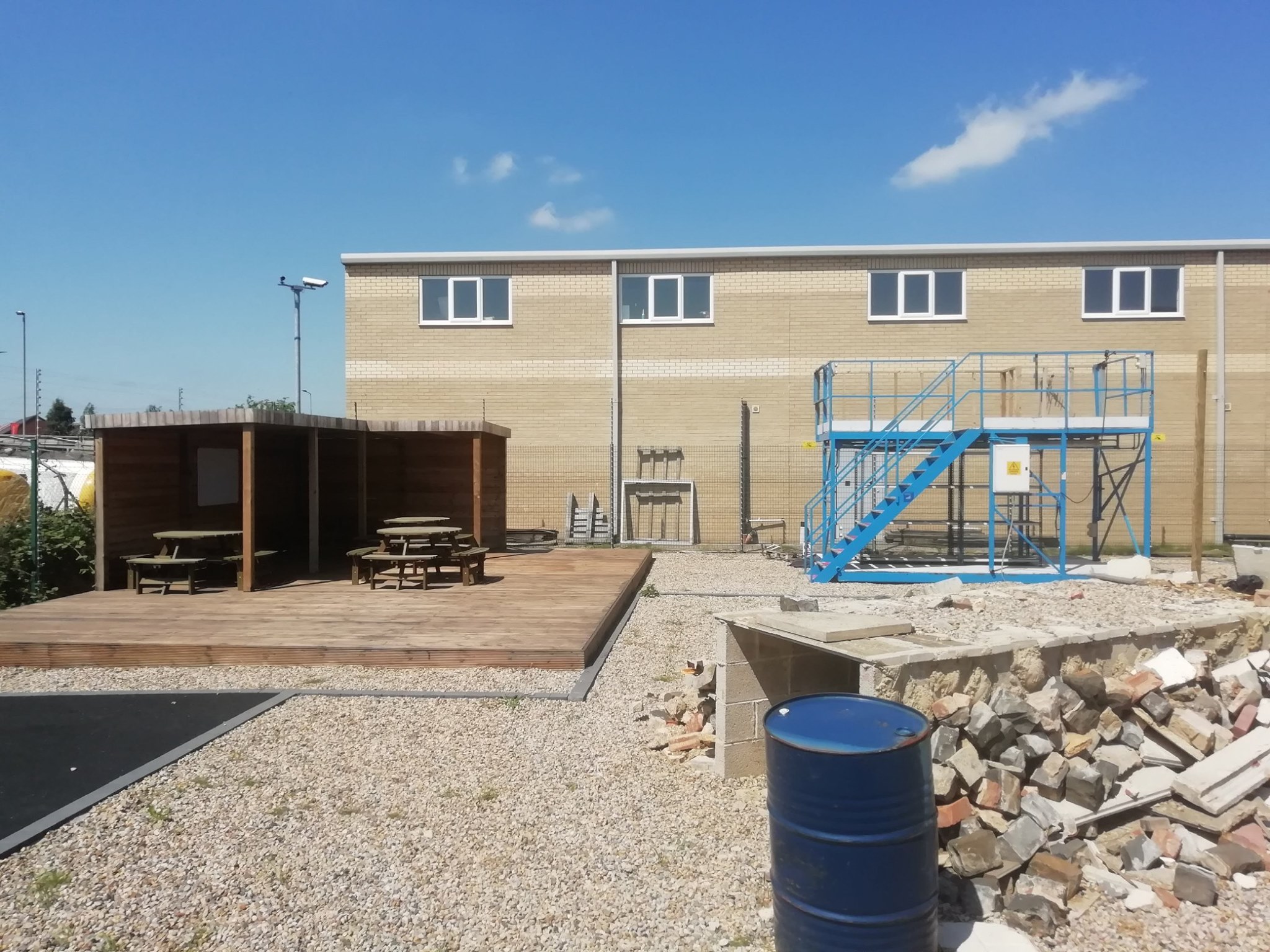 Outdoor simulation area at Faraday House with two-level training platform, picnic shelter and rubble rescue zone