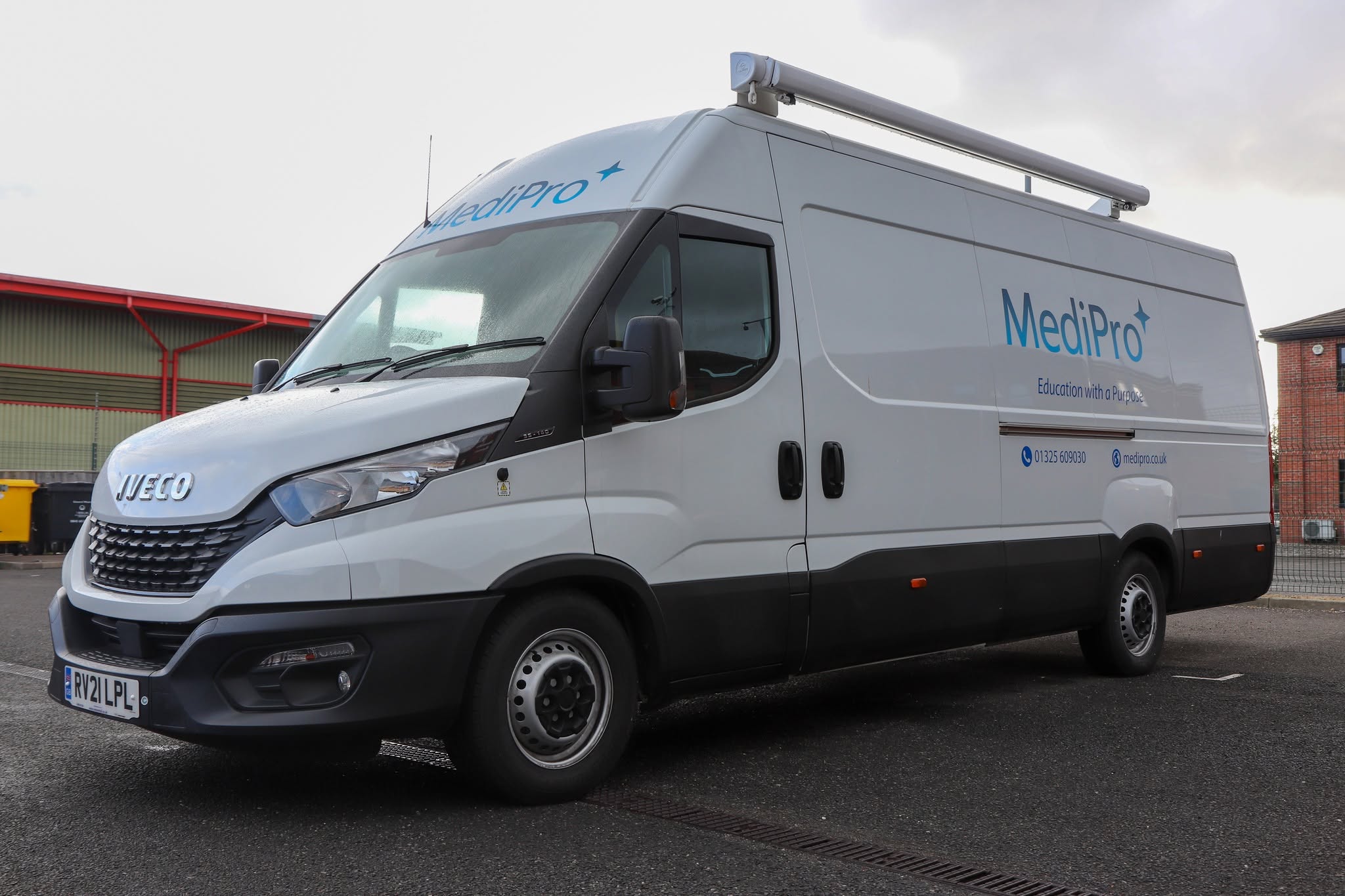 Medipro mobile education unit, a purpose-built van with awning, parked at a training site